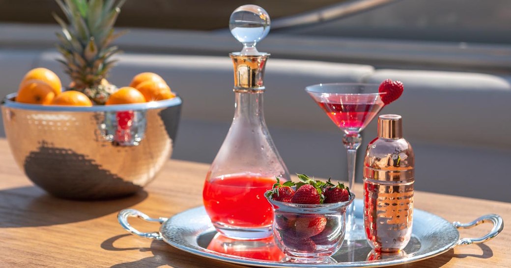 Bespoke cocktail set on silver tray with berries and fruit on Luxury charter yacht ANAMEL