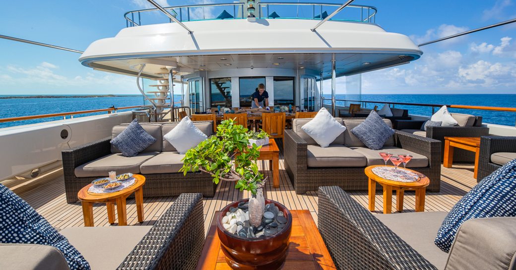 Afresco lounge area with rattan seating onboard yacht rental NITA K II