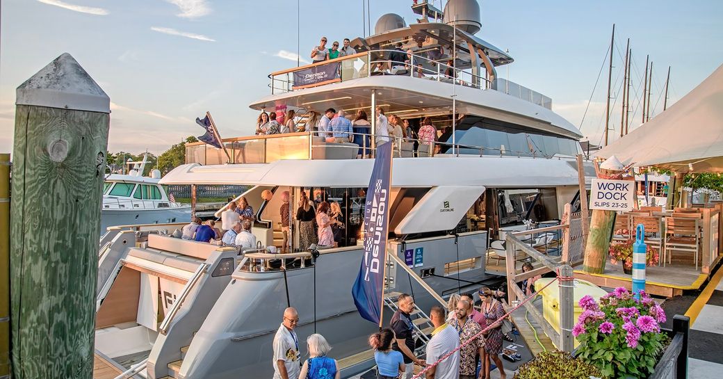 Superyacht charter berthed with show visitors viewing yacht