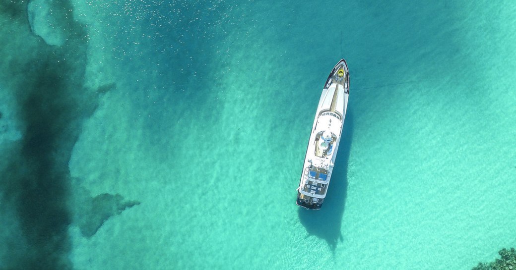 Yacht cruising in turquoise waters