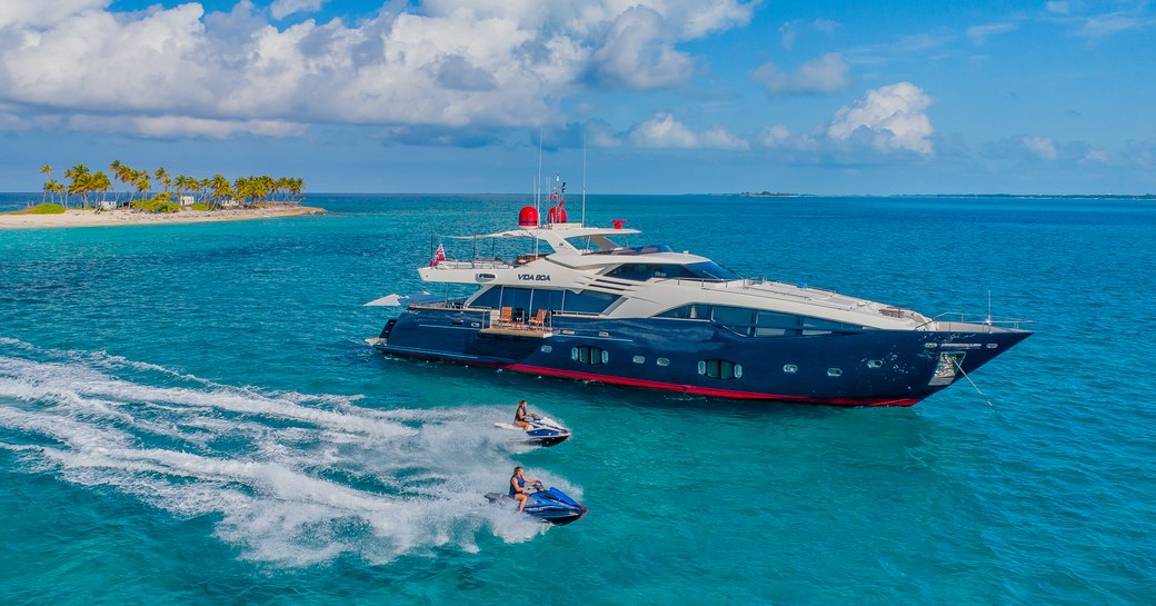 luxury yach vida boa surrounded by clear water in the bahamas