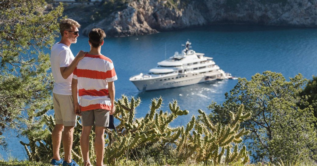 Here Comes the Sun in Mexico with guests in foreground looking at her on the water