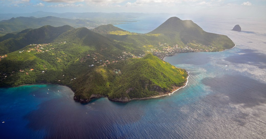 green-covered mountains and blue waters of Martinique in the Caribbean