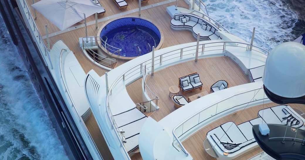 Aerial view of superyacht EQUANIMITY aft deck pool and seating areas