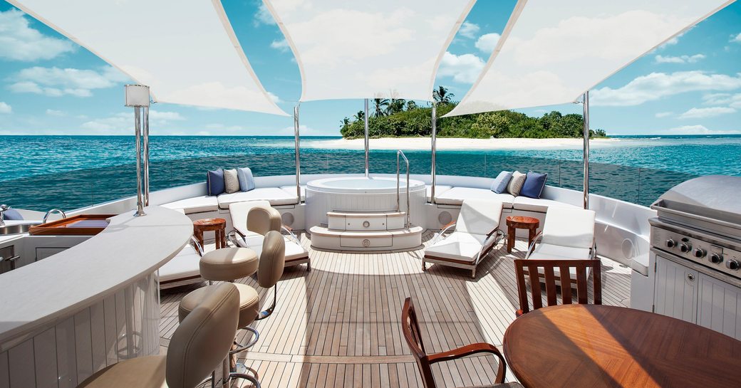 Jacuzzi, bar and dining area on sundeck of superyacht WILDFLOUR 