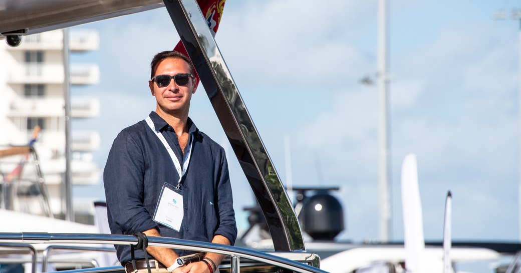 A male visitor to the Fort Lauderdale International Boat Show standing on a yacht.