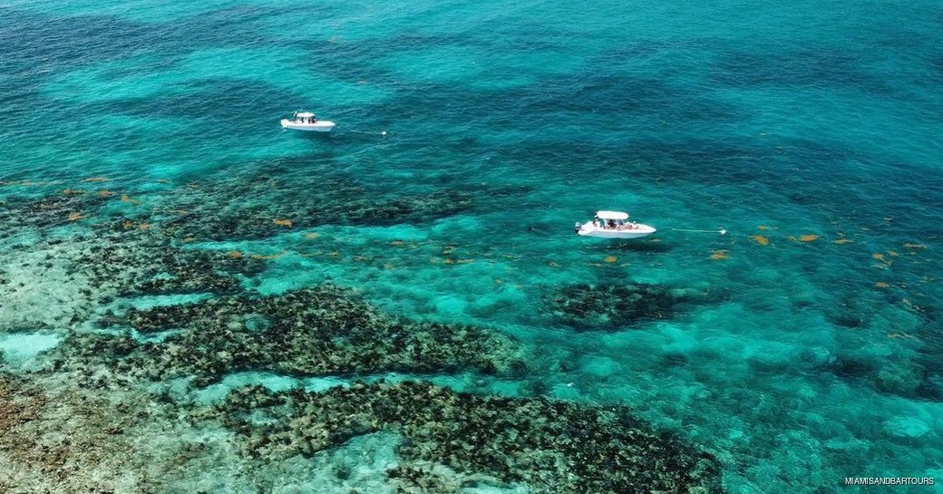 yachts just above the christ of the abyss monument dive site