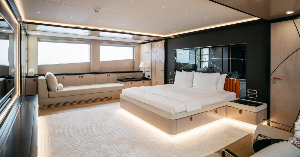 Master cabin with central berth and large wall-mounted TV onboard charter yacht HEEUS