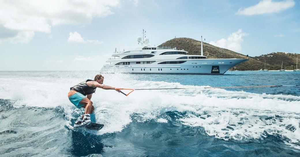 a man enjoying his yacht charter by playing some watersports near his luxury superyacht away from high risk zones of coronavirus