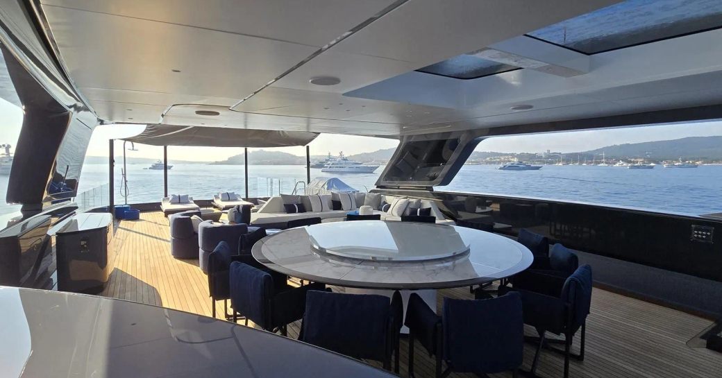 Alfresco dining option with circular table onboard yacht charter AKULA