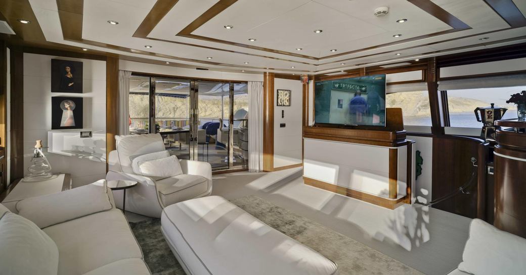 salon area on board superyacht bunker, with white sofas and exterior set-up