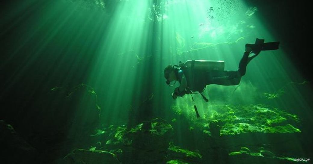 Diver n an underwater cave in Lucayan National Park 