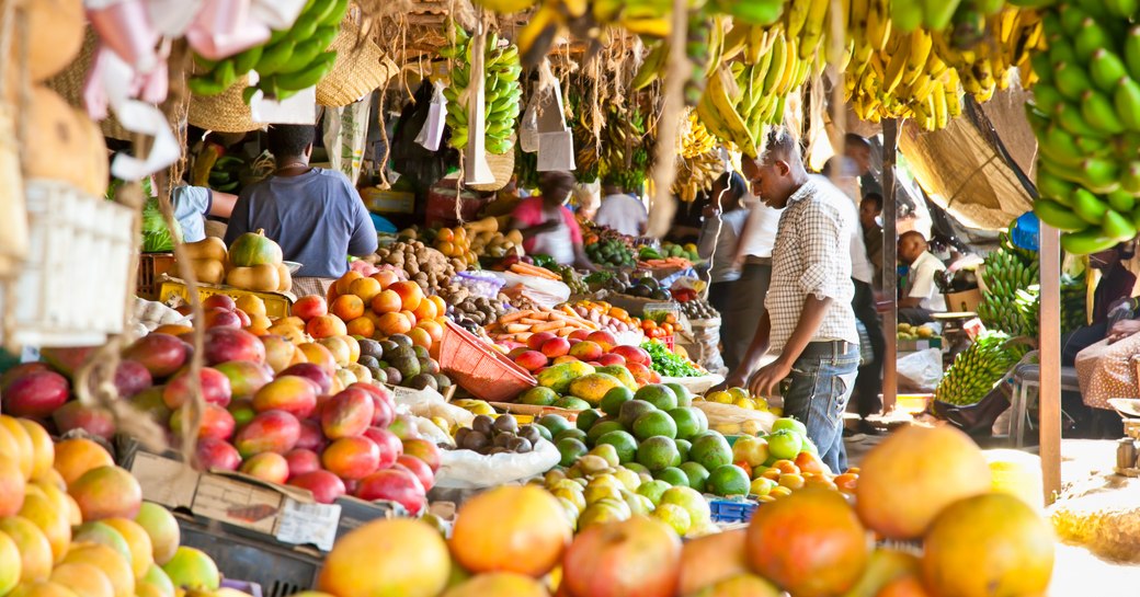 A man browses a fruit stall in a busy market in Nevis, Caribbean