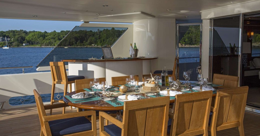 Alfresco dining set-up on superyacht Far Niente, with views over Bahamas in background