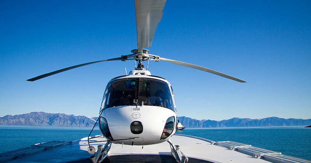 Helicopter on the deck of charter yacht ASTERIA