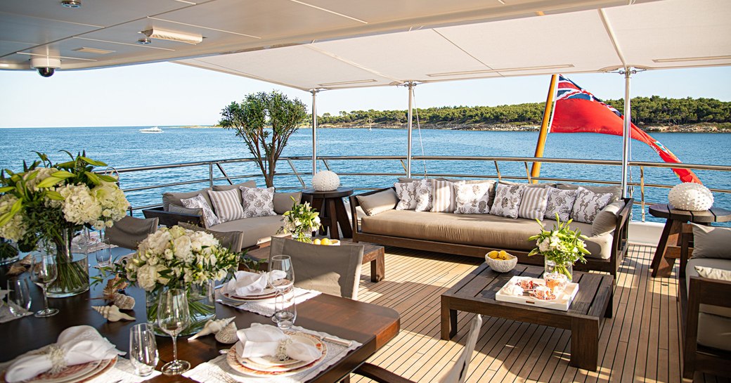 alfresco dining area and sofa seating on superyacht spirit