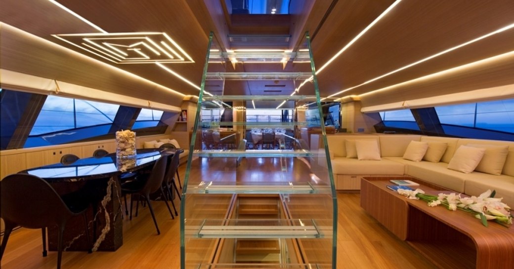 Overview of the main salon onboard charter yacht OHANA, with lounge area to starboard and dining port side