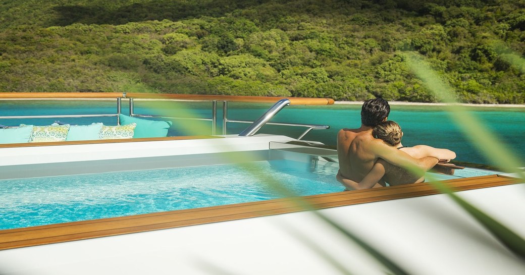 Charter guests enjoying the pool on board superyacht SOLANDGE