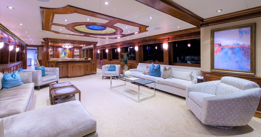 large sofas and armchairs in the main salon aboard motor yacht EXCELLENCE