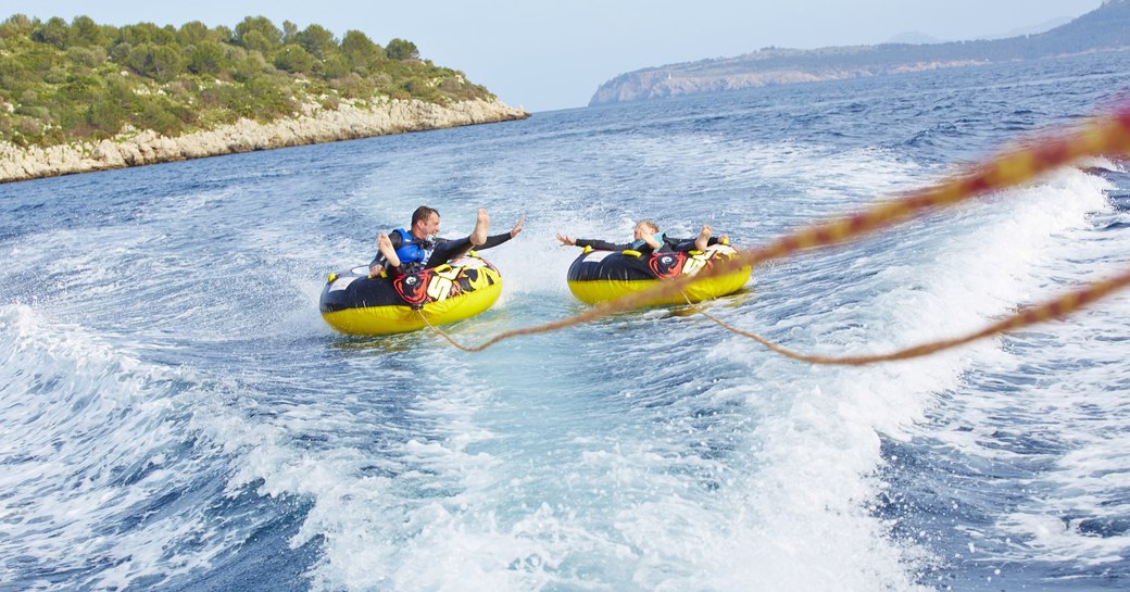 charter guests enjoy inflatable toys on superyacht spirit 