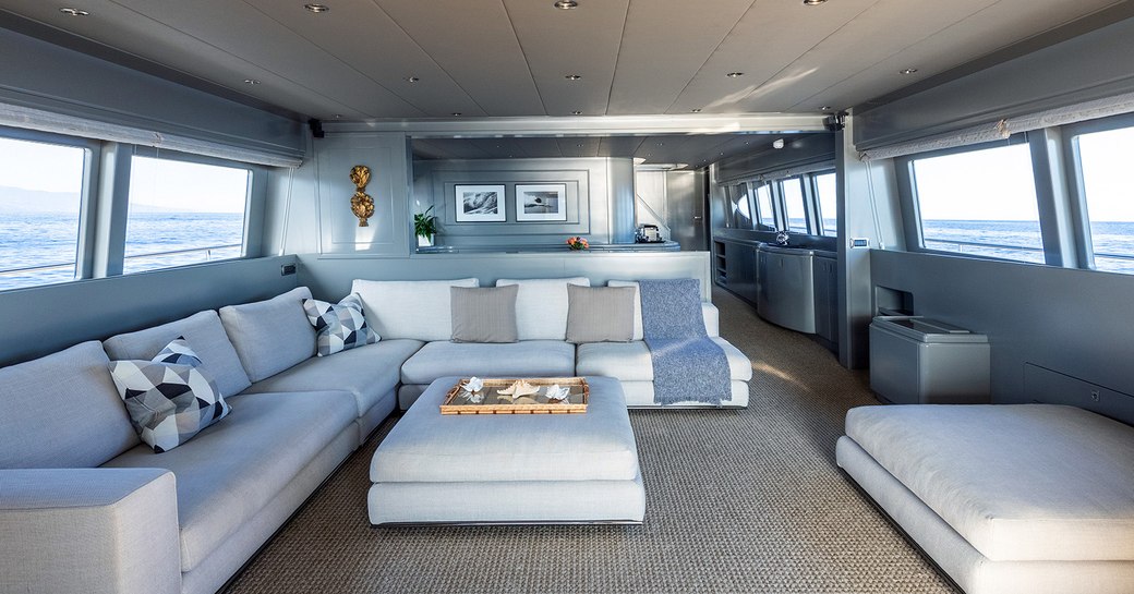 Open plan salon with sofas and ottomans on Mondo Marine motor yacht TALILA