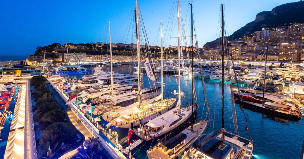 Overview of Port Hercule at dusk with many yacht charters berthed