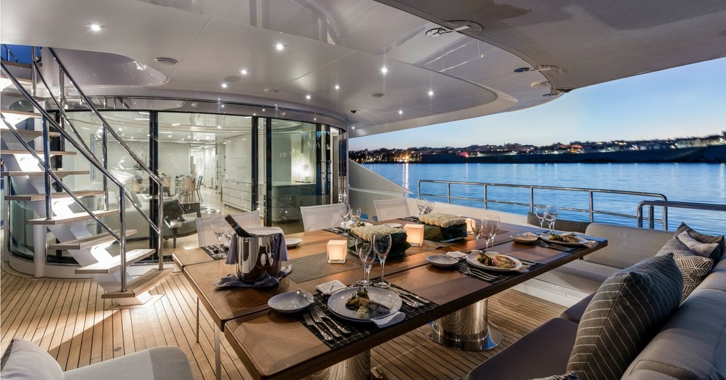 Al fresco dining space and main salon on superyacht Her Destiny