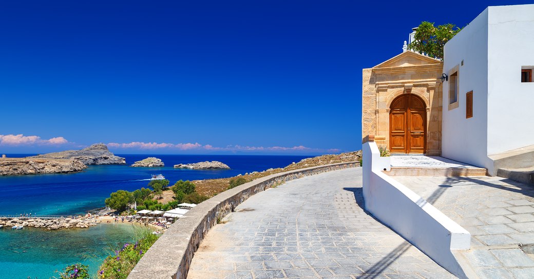 chapel overlooking little bay in greece