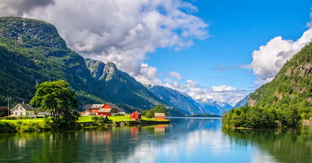 Norwegian landscape with Nordfjord fjord, mountains, flowers and glacier in Olden, Norway