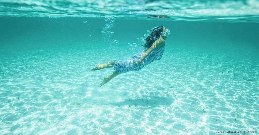 Underwater shot of a woman swimming in the Cay's waters