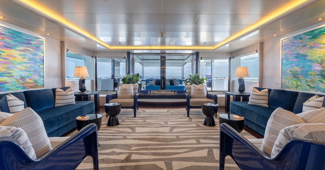 Main salon with blue seating onboard charter yacht ETERNITY