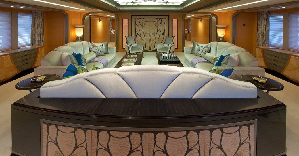 Lounge area onboard yacht charter AMARYLLIS, sofas facing each other with low coffee table between.