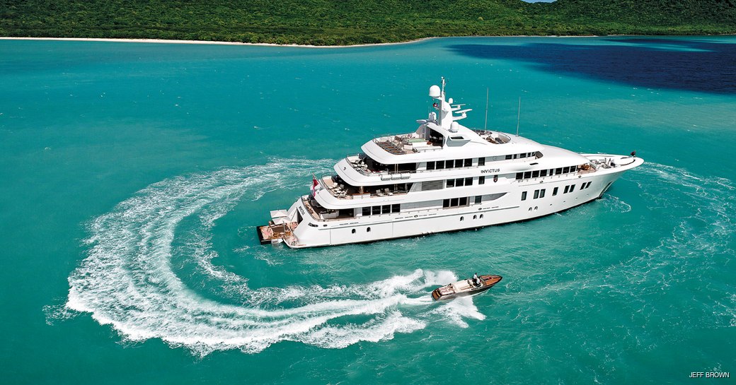 invictus yacht at anchor with tenders around her