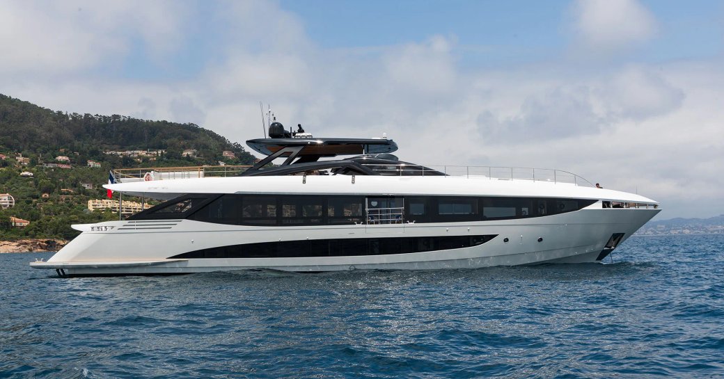 Charter yacht LAFAYETTE at sea, with raised terrain in the background