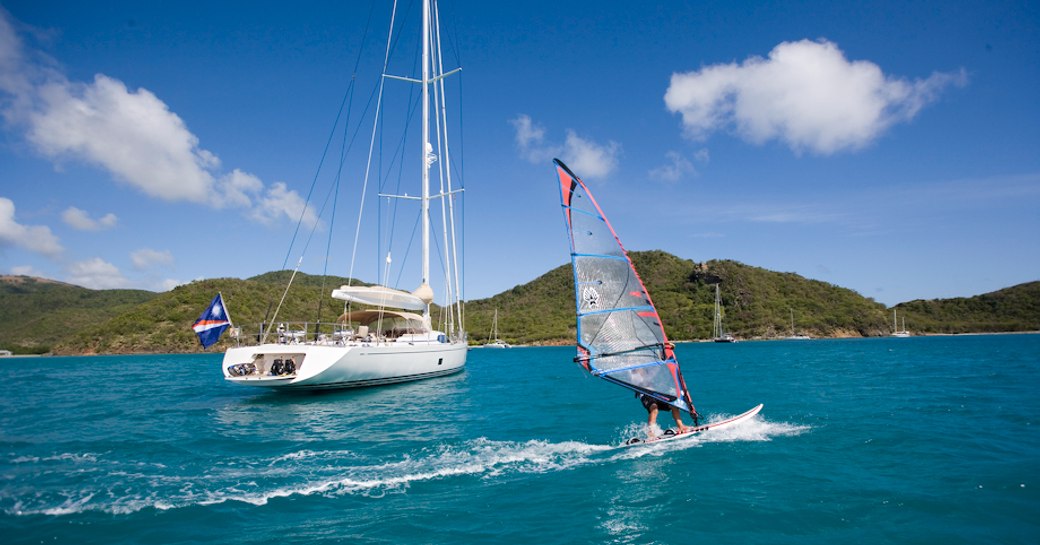 sailing yacht RAPTURE docks in an idyllic anchorage as charter guests try out her water toys