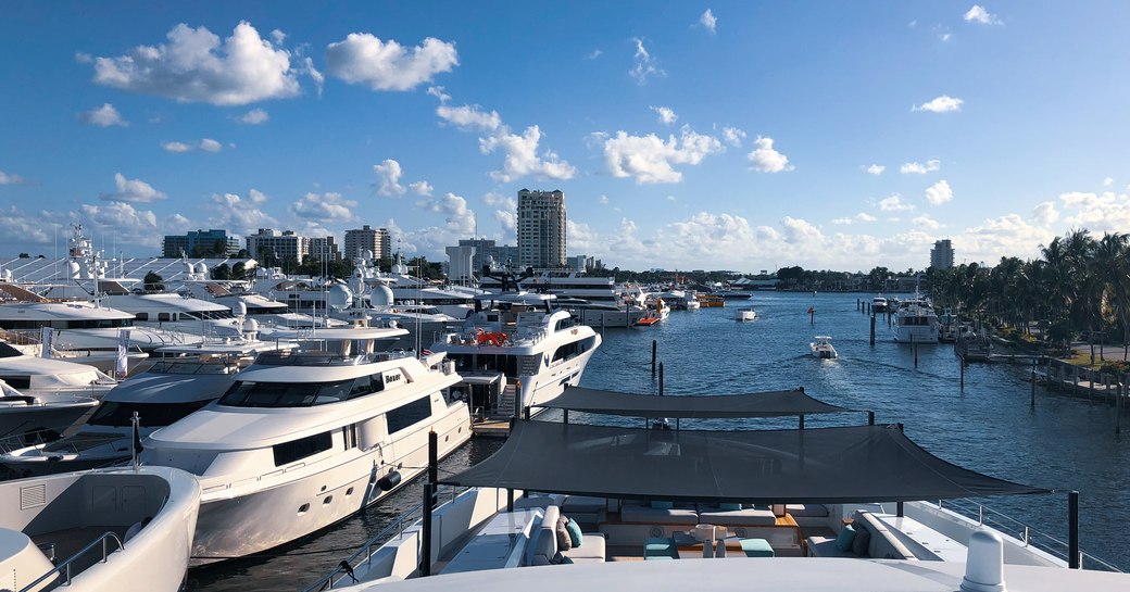 Yachts at FLIBS 2019, with river canal and city skyline in background