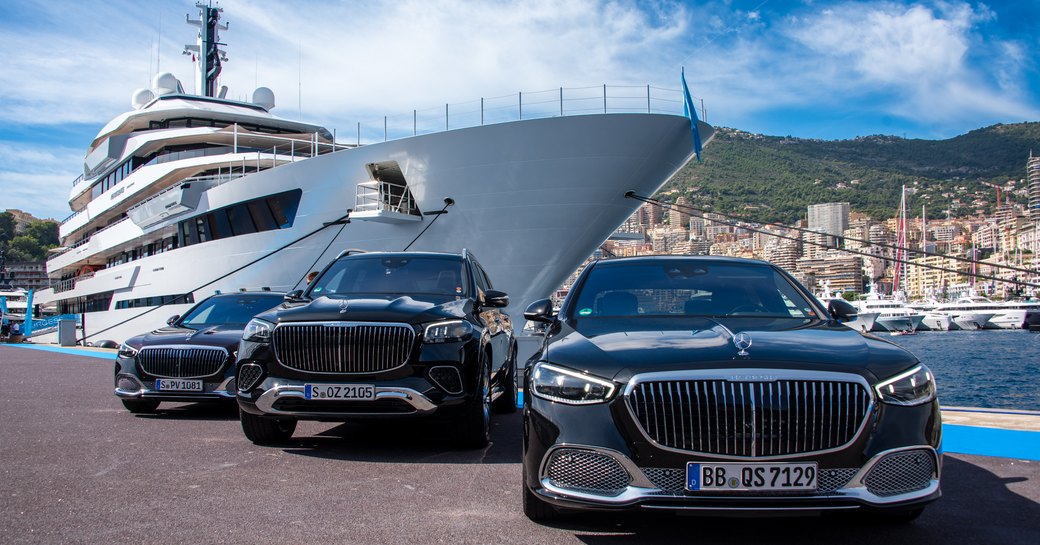 Charter yacht RENAISSANCE berthed in Port Hercule with trio of black cars on the dock