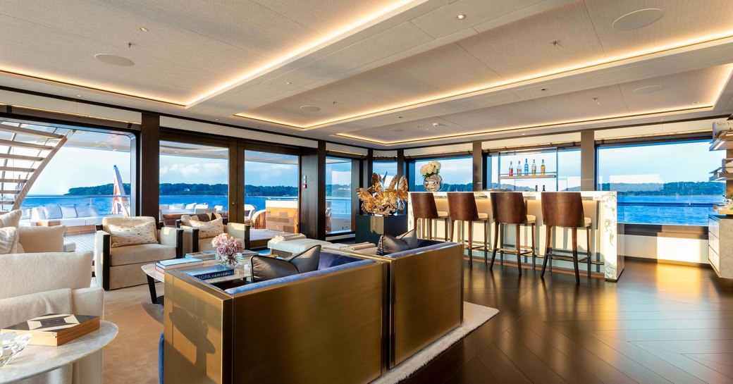 ibiza style interiors on superyacht hasna, with backlit onyx bar