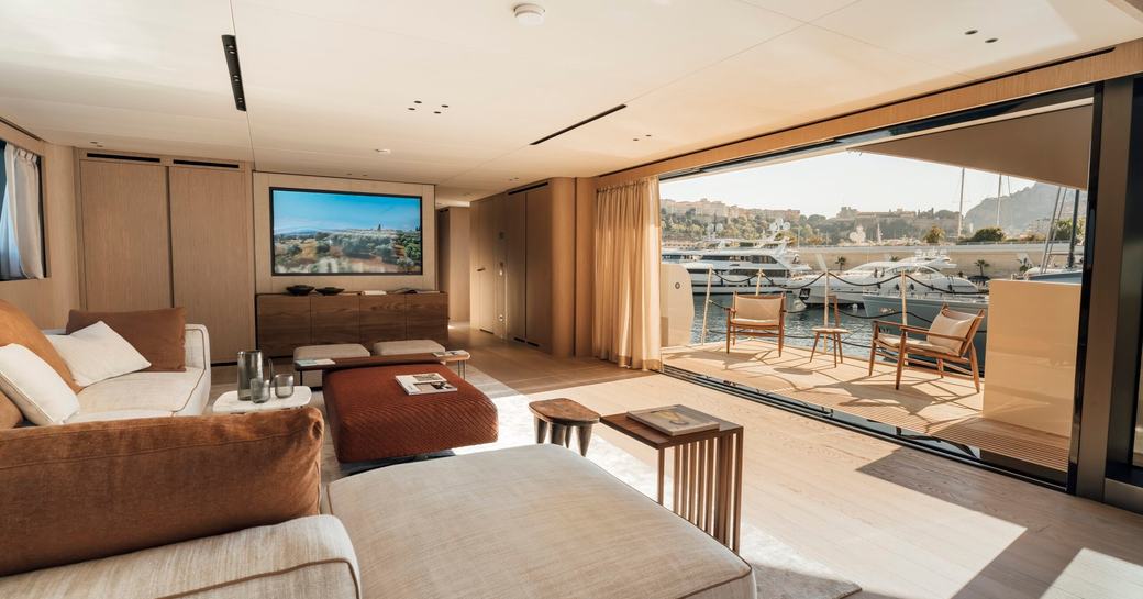 Overview of interiors and open balcony with seating onboard charter yacht ANDIAMO