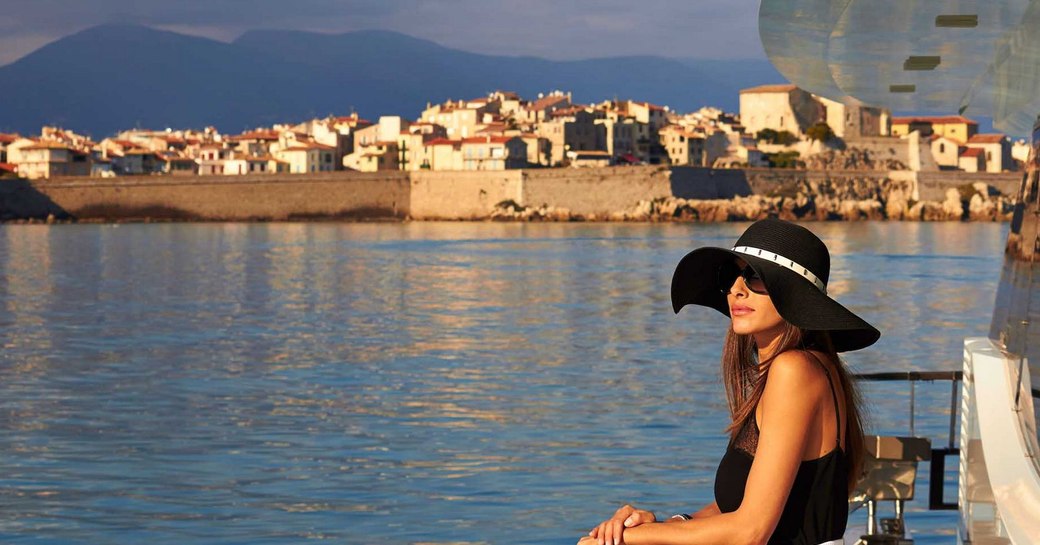 woman stands on yacht overlooking the south of france