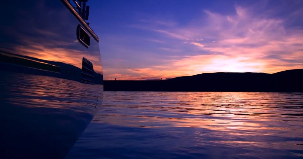 Sailing yacht ROSEHEARTY against a purple skyline