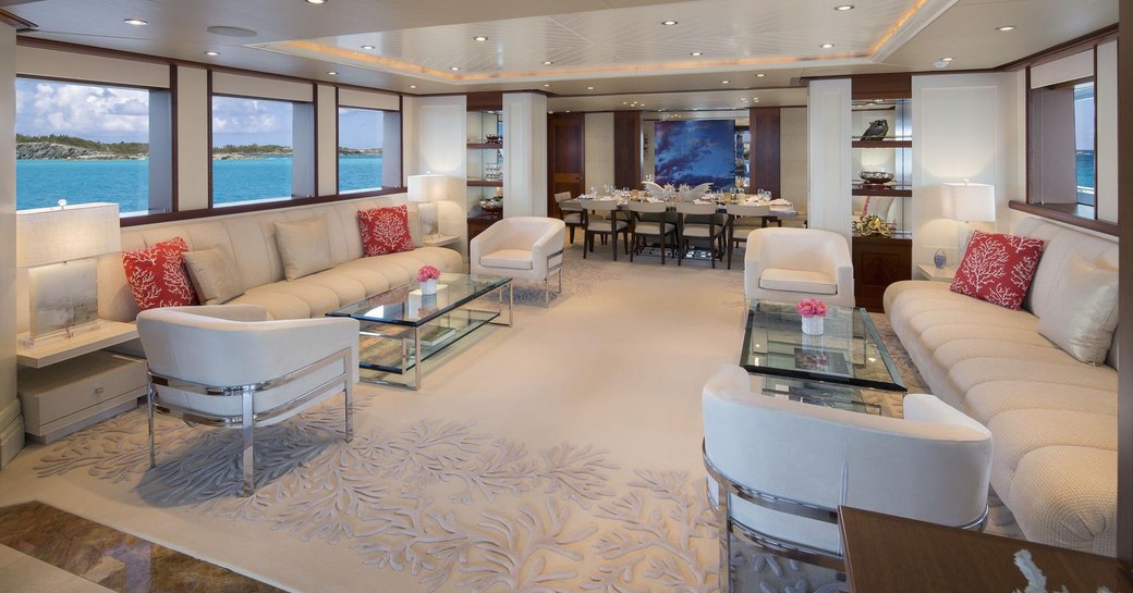 large sofas and armchairs form sociable seating area in the main salon of superyacht Time For Us 