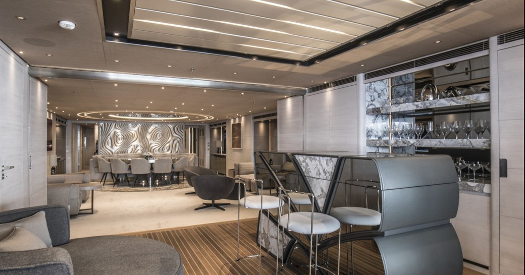 main salon on luxury yacht severins, with geometric bar and dining area