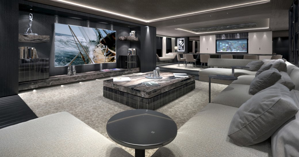 huge U-shaped sofa faces widescreen TV in main salon aboard luxury yacht SOLO