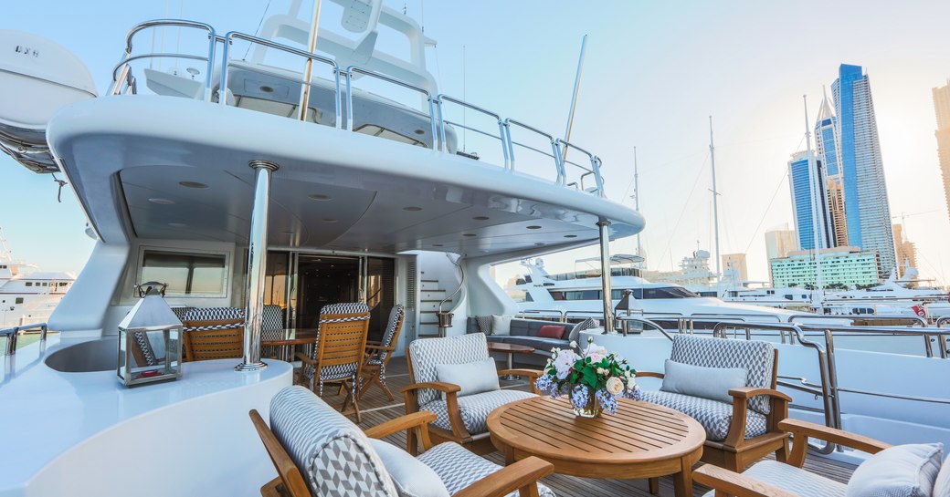 upper deck aft of luxury yacht DXB with lounging area and alfresco dining setup