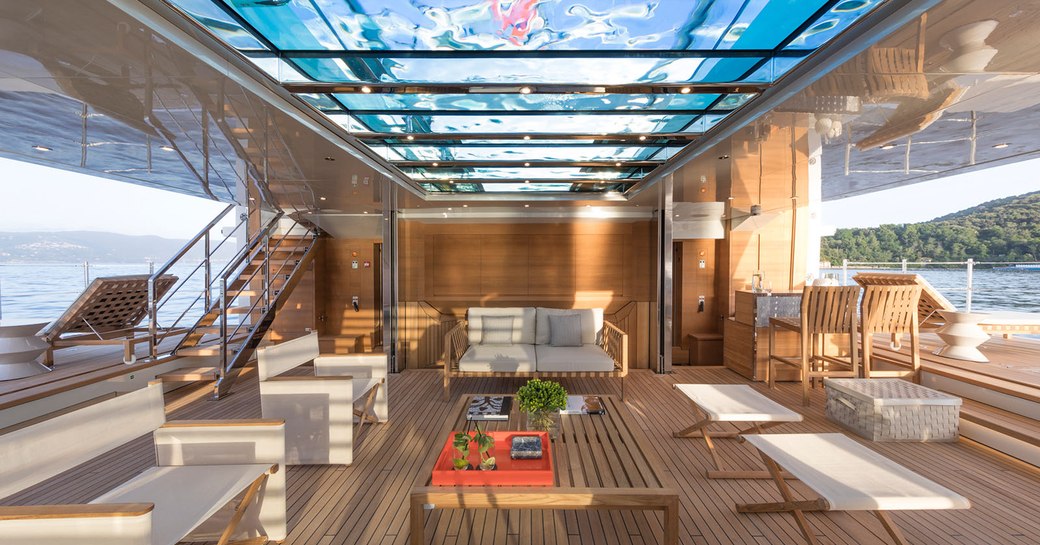 glass bottomed pool on luxury yacht lady lena, with beach club below