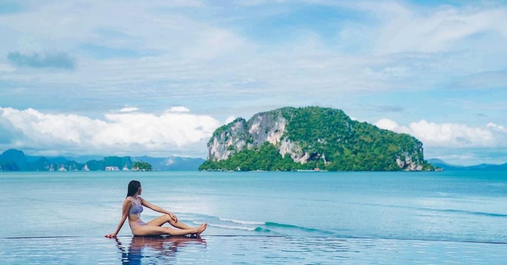 woman sat on beach at koh yao yai