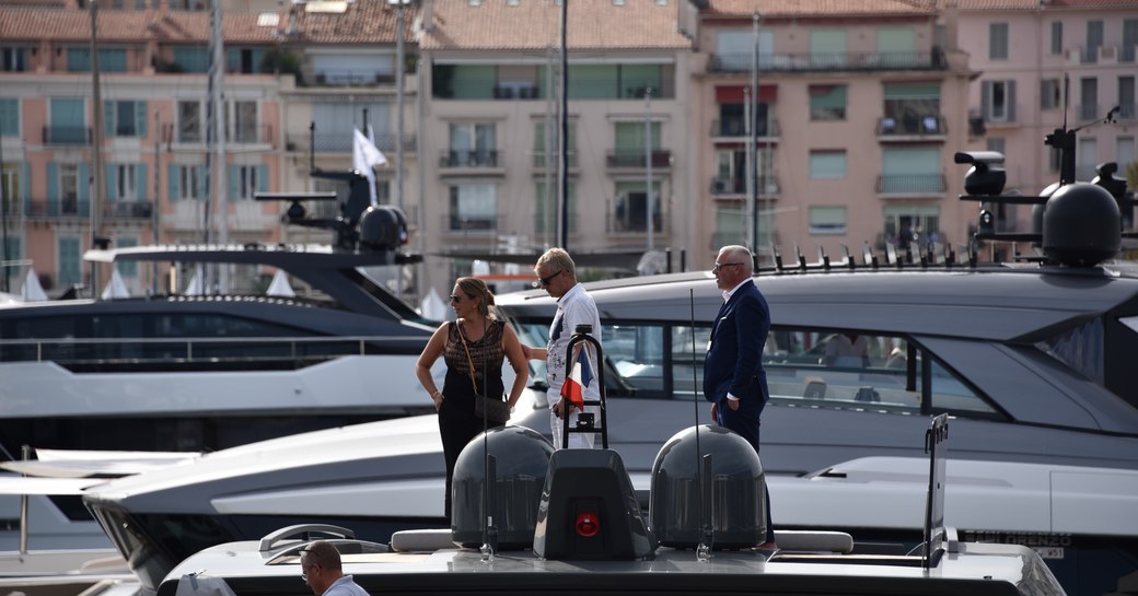 woman stands on the deck of a yacht in cannes during the boat show