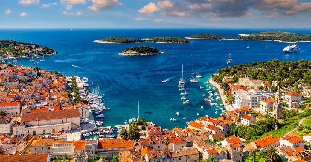 Overview of Hvar, Croatia. Elevated view looking out over rooftops towarda sea and archipelago.