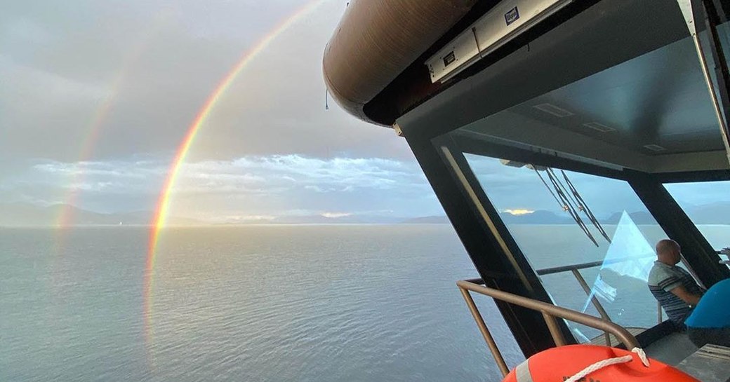 rainbow over the sea as seen from the bridge of rev ocean yacht